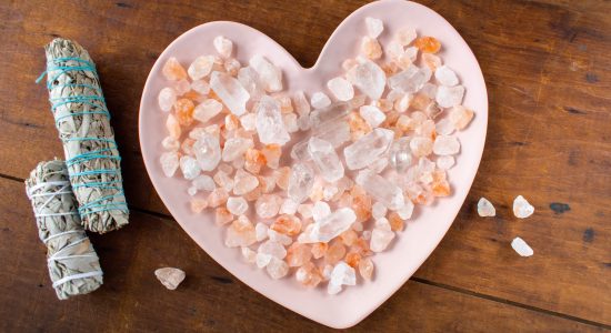healing heart shaped plate filled with crystals with two sage sticks healing heart shaped plate filled with crystals with two sage sticks